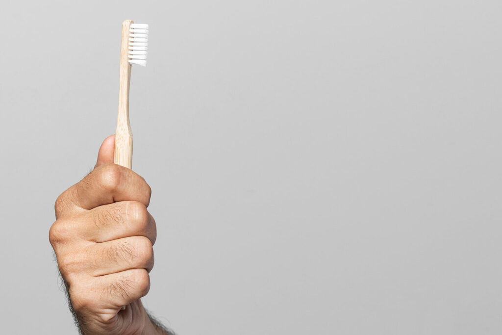 Close Up Hand Holding Toothbrush