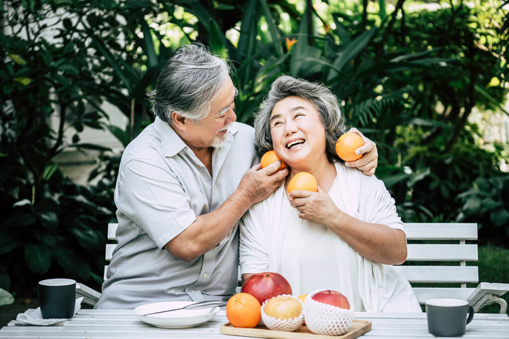 Elderly Couples Playing Eating Some Fruit